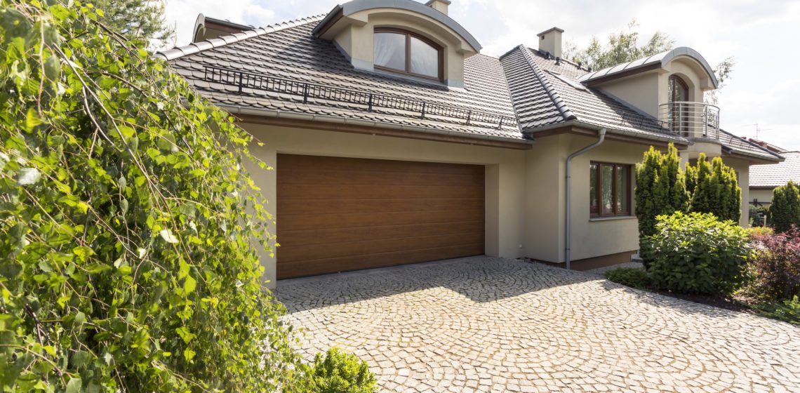 Detached house exterior with cobblestone driveway
